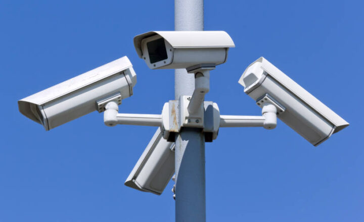 Four security cameras on blue sky