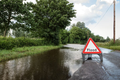 country road in UK with flood warning sign